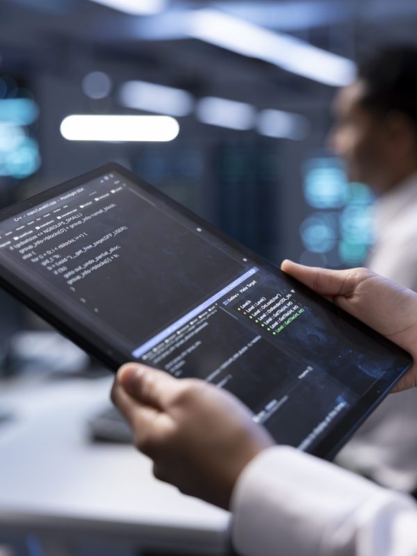 Manager in server hub using tablet to find firewall misconfigurations affecting rackmounts performance. Supervisor checking systems bottlenecks leading to sluggish data transfer rates, close up